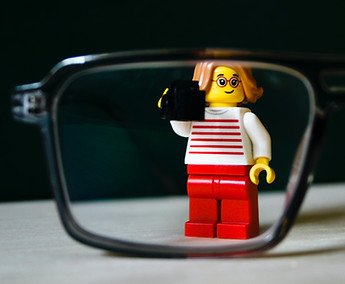 Lego Mini-Figure taking photo through glassess