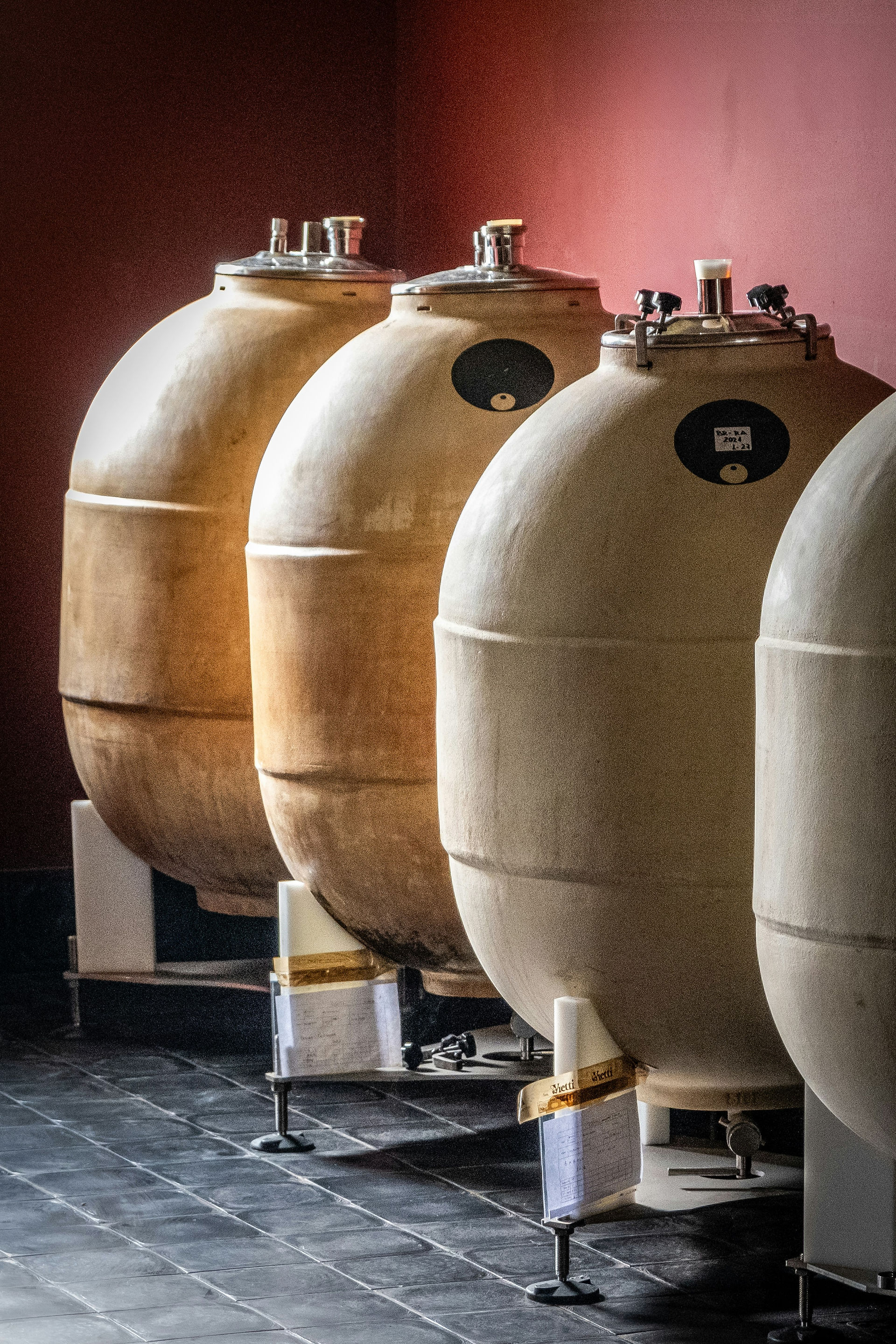 A row of amphorae that is used to age wine. Photo by Sue Winston / Unsplash
