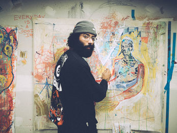 A painter looking back as he sketches out his next artwork.