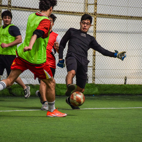 Young footballers challenging for the ball during a five-a-side match, the kind of match sharpness football pre season training helps build for players across Bournemouth, Poole and Christchurch