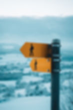 Two direction panels over a wintery background