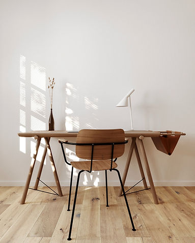 Modern wood desk and chair representing the clean and modern website design we offer mental health private practices in Canada