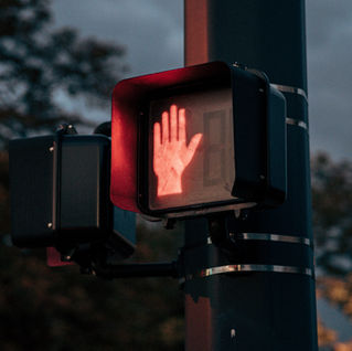 "no walking sign" with red illuminated hand, indicating how some men feel towards counselling.