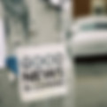 A flyer that says good news stapled on to a tree trunk