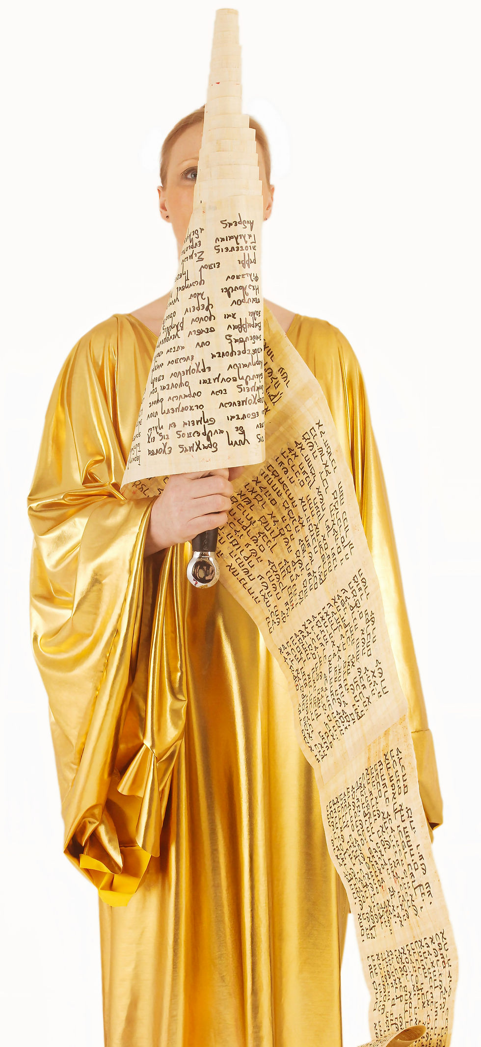 Person in a flowing gold robe holding a scroll with handwritten text. The background is plain white, emphasizing the vibrant attire.