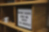 a sign showing business ethos of work hard and be nice to people