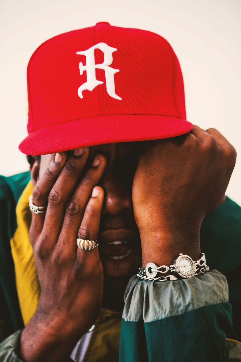 Man wearing a red snapback hat.