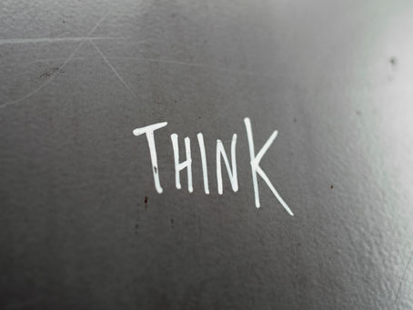 A minimalist photograph of an empty space with the single word “Think” displayed prominently, evoking reflection and intellectual stillness.