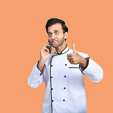 A chef on the phone giving a thumbs up