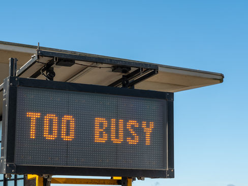 An electric sign post that says Too Busy