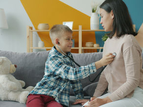 a boy doing pretend play as a doctor