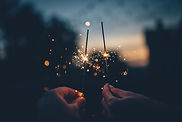 two hands holding sparklers