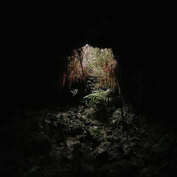 Inside Kaumana Caves on the Big Island of Hawaii, featuring ancient volcanic lava rock formations, dramatic underground lava tube landscapes, and rugged cave walls formed by historic Mauna Loa eruptions. This natural volcanic cave offers a unique glimpse into Hawai‘i’s geological history and volcanic beauty.