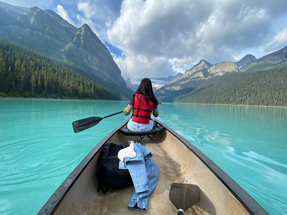 Canoeing on Lake Louise with turquoise water and mountain views in Banff National Park, Canada.