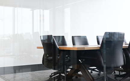 A conference room table with office chairs