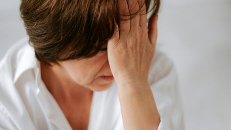 A woman holding her head