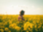 Woman ready to change her life surrounded by tall yellow flowers