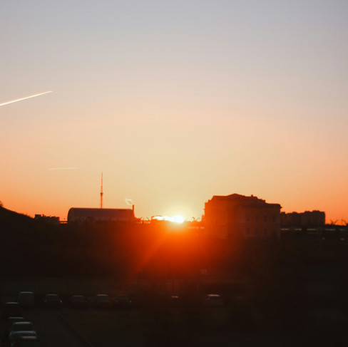 Sunrise over the city representing optimism, progress, and a positive orange morning mindset.