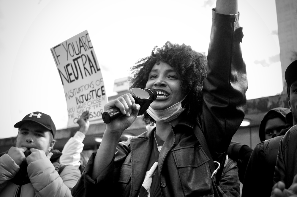 March with a lady protesting against racial inequality