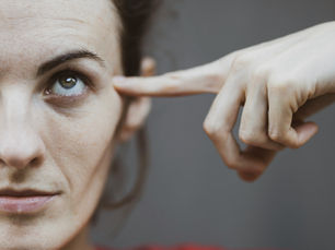 woman pointing at eye