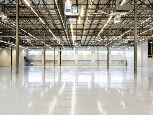 Interior of a large empty commercial warehouse with polished concrete floors