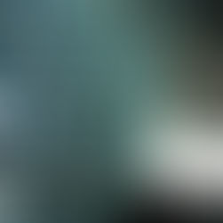 People stand by a geometric glass window with hexagonal patterns, casting reflections. The setting is modern with a bright ambiance.