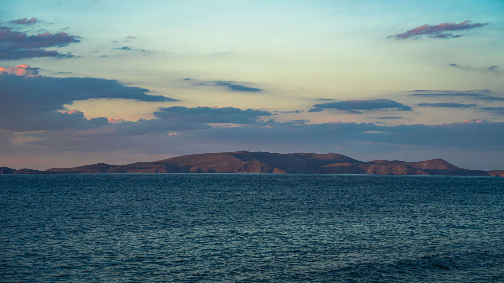 Sunset over Aegean Sea during Heraklion Riviera sailing experience in Crete