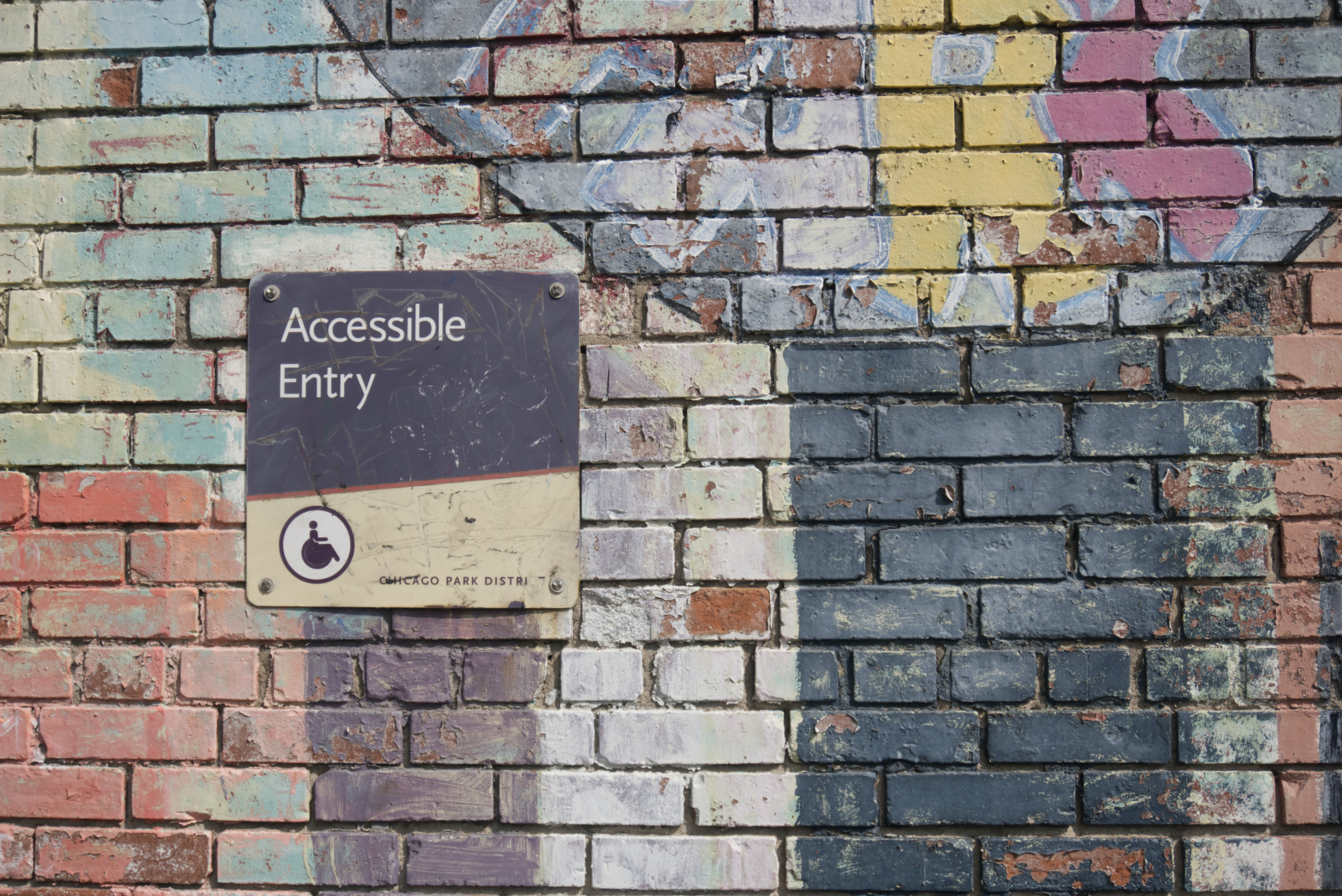 sign on brick wall "accessible entry"