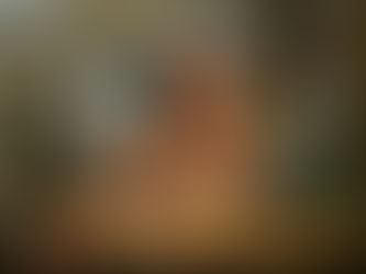 Black woman alone at table thoughtful