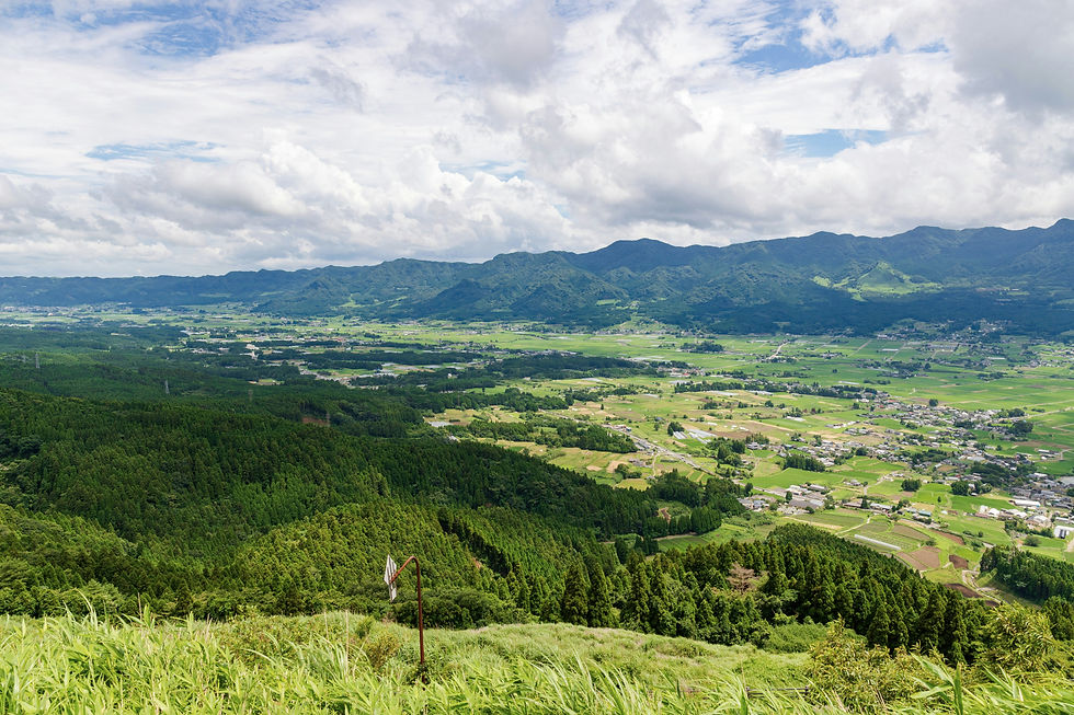 Eye-level view of Mt Aso's vast volcanic caldera under a clear blue sky