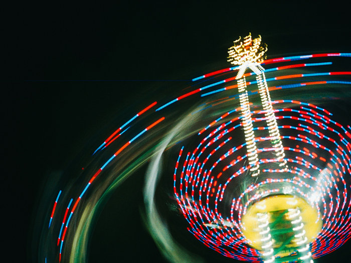 Fairground ride spinning in light trails at night
