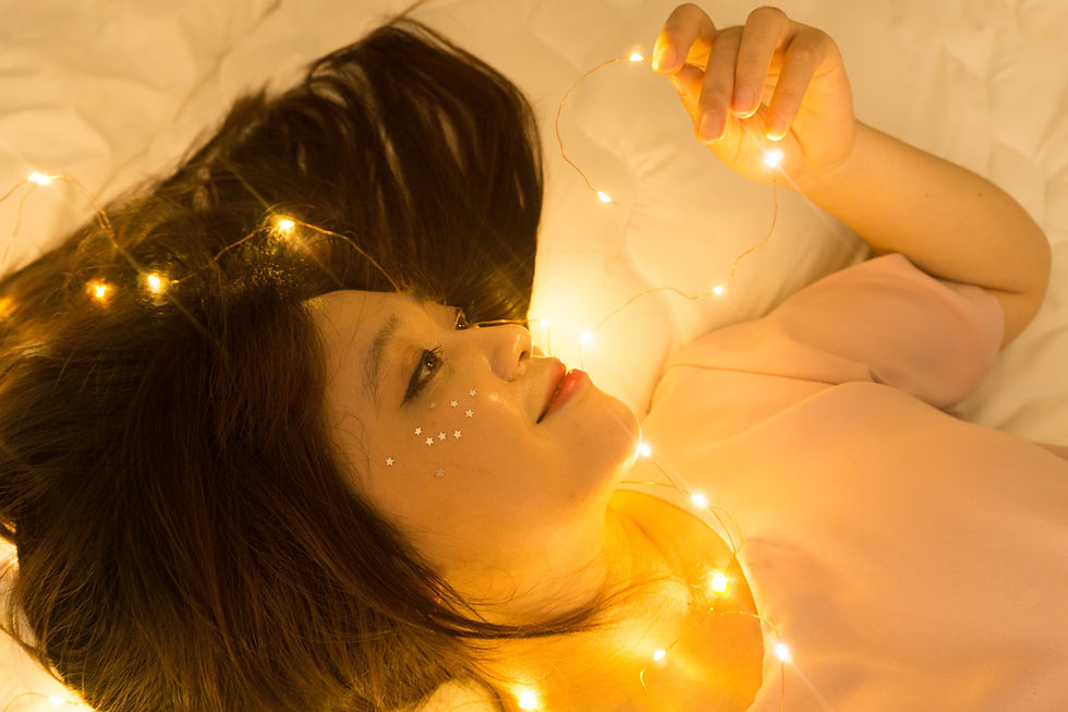 Picture of a beautiful woman lying on a bed of an article about lesbian poetry and erotic lesbian poems