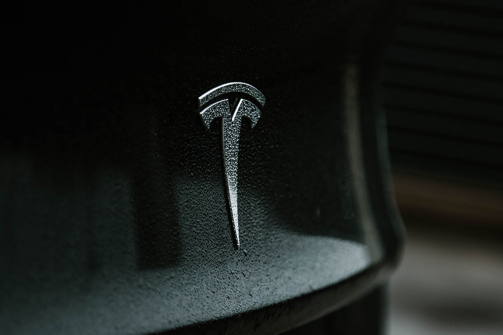 Tesla logo on back of a black car