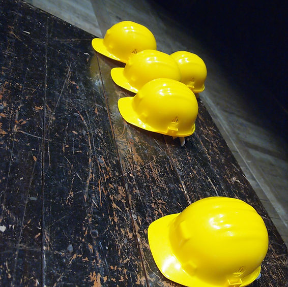 Yellow hard hats sitting on table for construction workers