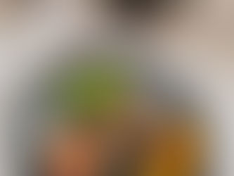 Plate with rice, beans, avocado, plantains, salsa, and tortillas. Coffee cup and water glass on a wooden table. Calm outdoor setting.