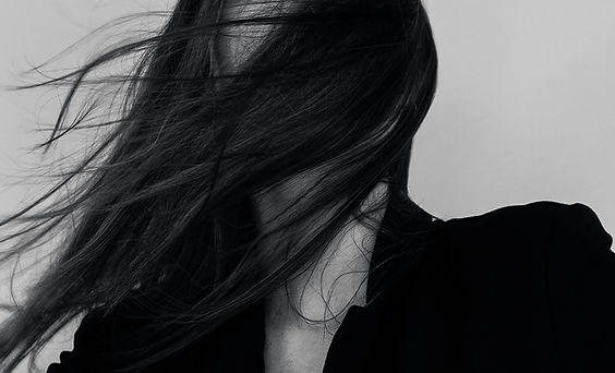 black and white editorial photo of woman running outdoors, off-duty model aesthetic