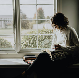 woman reading in window seat