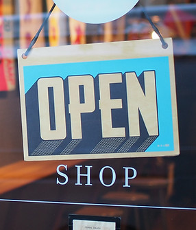 An open sign showcasing the sign and banner printing services offered