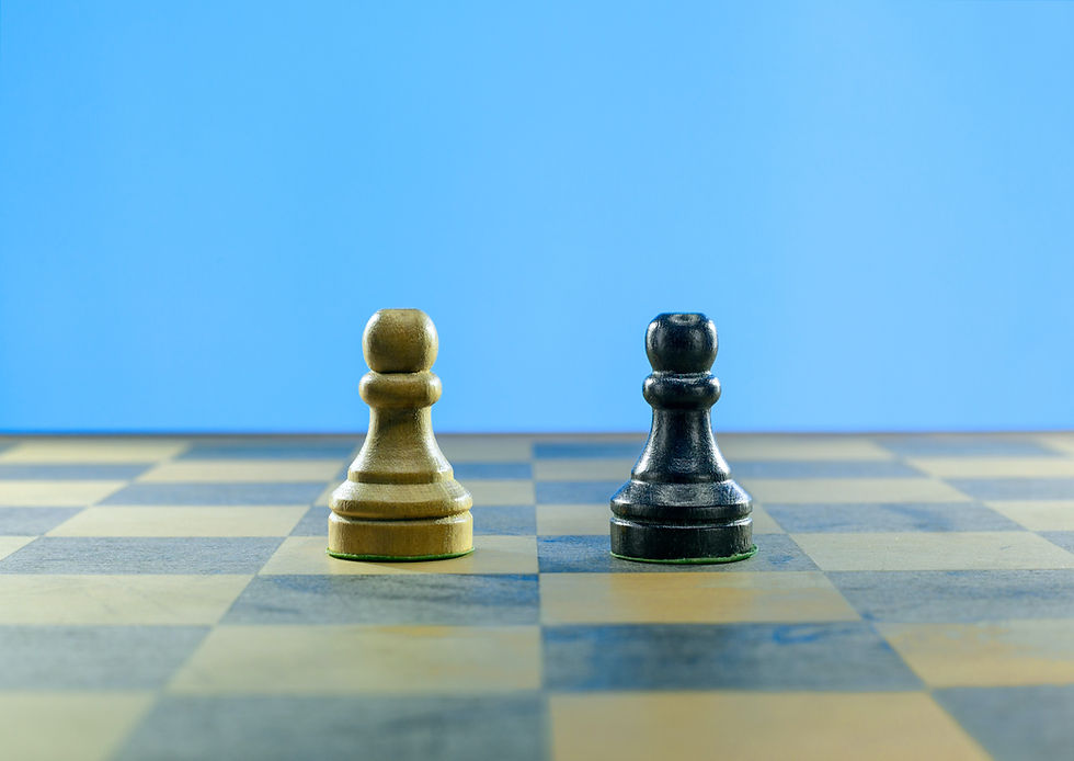 Two chess pawns, one white and one black, face each other on a checkered board against a blue background, suggesting a calm mood.