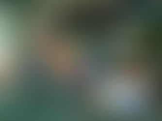 Woman in ethnic dress looks tired, resting hand on car wheel. Child sits in back seat. Interior is beige; mood is somber.