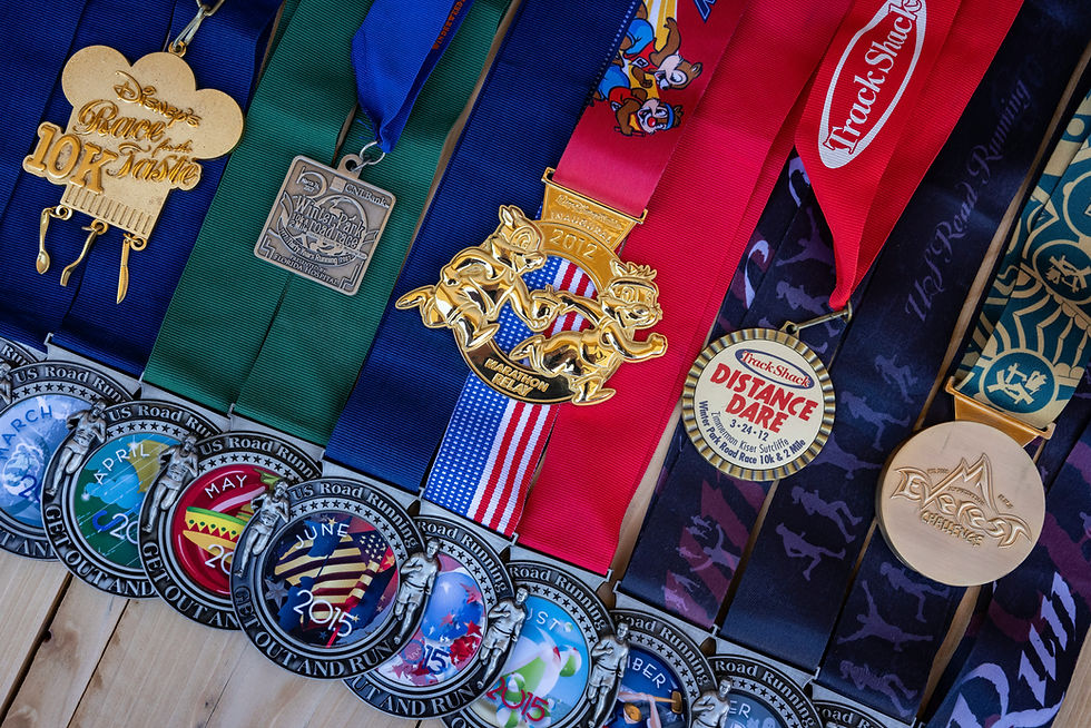Colorful array of marathon medals on a wooden surface, featuring ribbons and intricate designs. Text includes "Disney's Race" and "Distance Dare."
