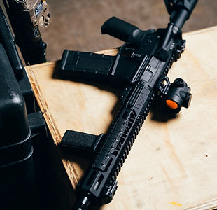 Modern rifle placed on table representing firearms technology and equipment