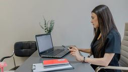 Healthcare administrator reviewing rehabilitation billing information on a computer