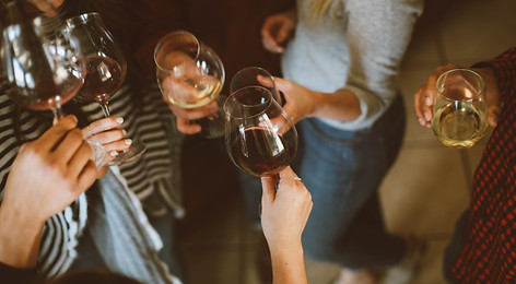 A group of locals and expats gathered in Montefrío town square, enjoying food, drinks, and conversation in a relaxed community setting.