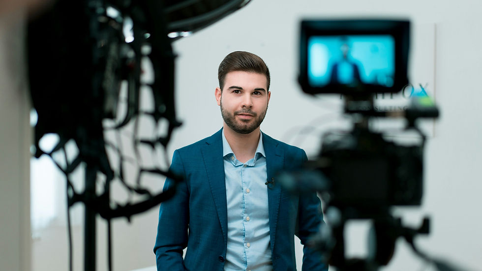Person being filmed by a bank of television cameras, representing intense media attention, public scrutiny, fame and life in the public eye.
