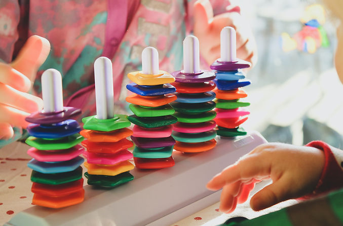 Child playing with colorful toy in speech therapy in Jacksonville, FL