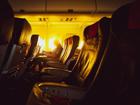 Airplane cabin seats. Warm ambiance, sunny interior.