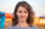 Headshot photograph of young woman outdoors for use on LinkedIn