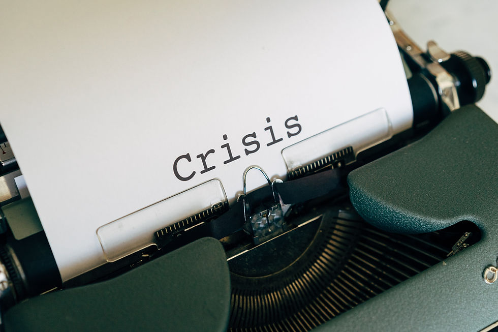 A typewriter with paper that says the word Crisis