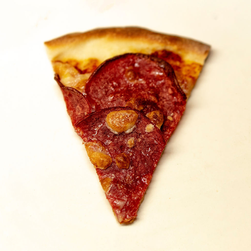 Close-up of a pepperoni pizza slice with crispy crust and melted cheese, set against a plain white background.